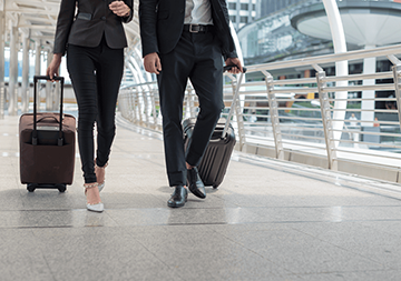 Two people with suitcases 
