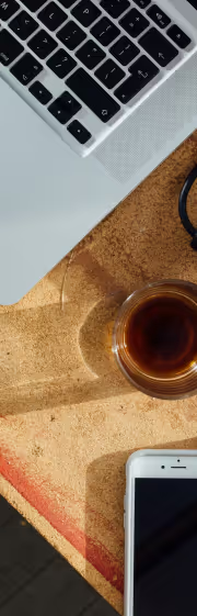 A laptop, a coffee mug and a phone