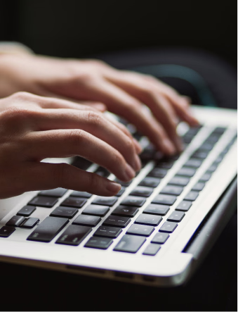 A person typing on a laptop